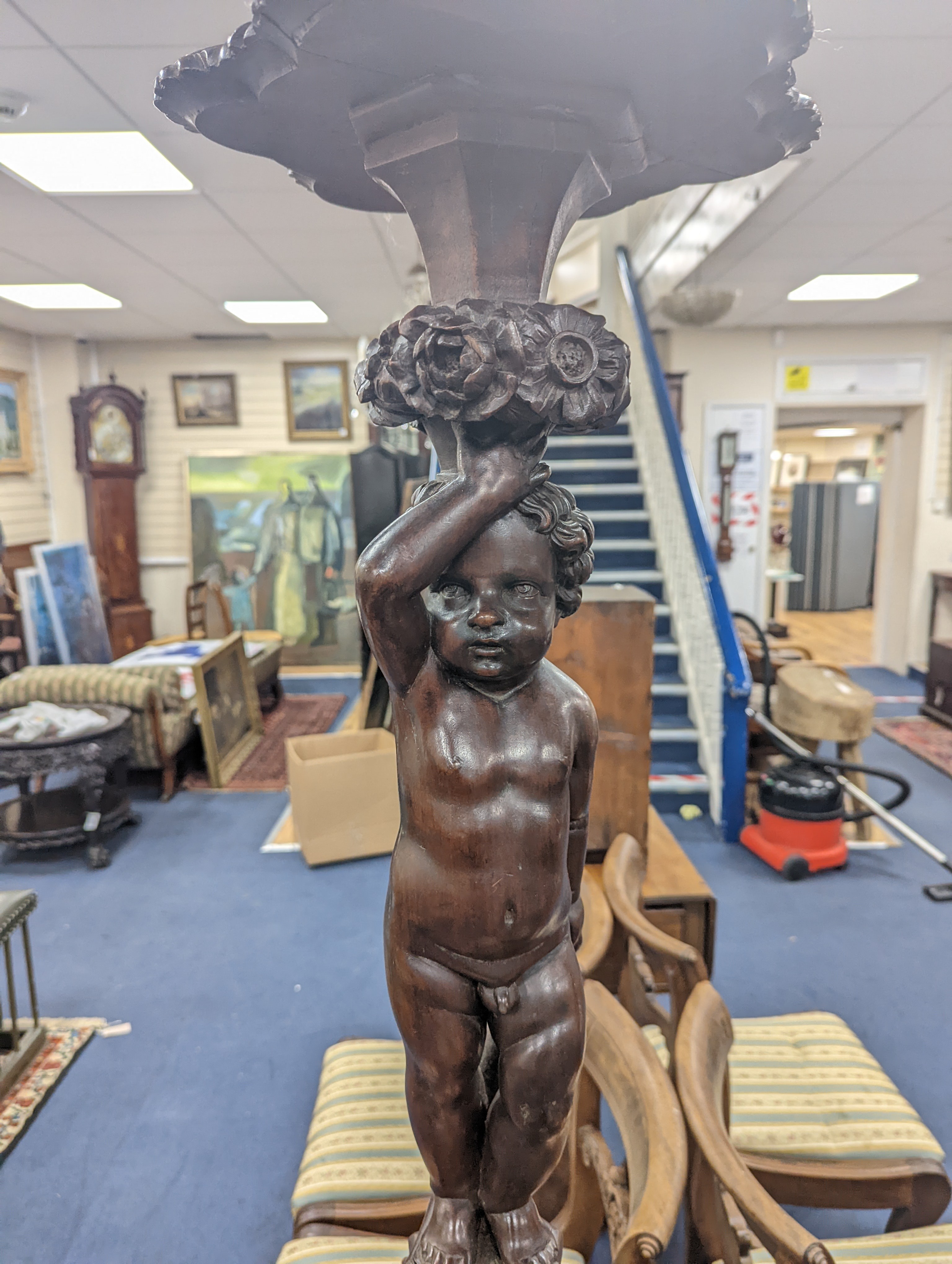 A pair of 18th century style Italian carved walnut figural torcheres with cherub stems, height 96cm